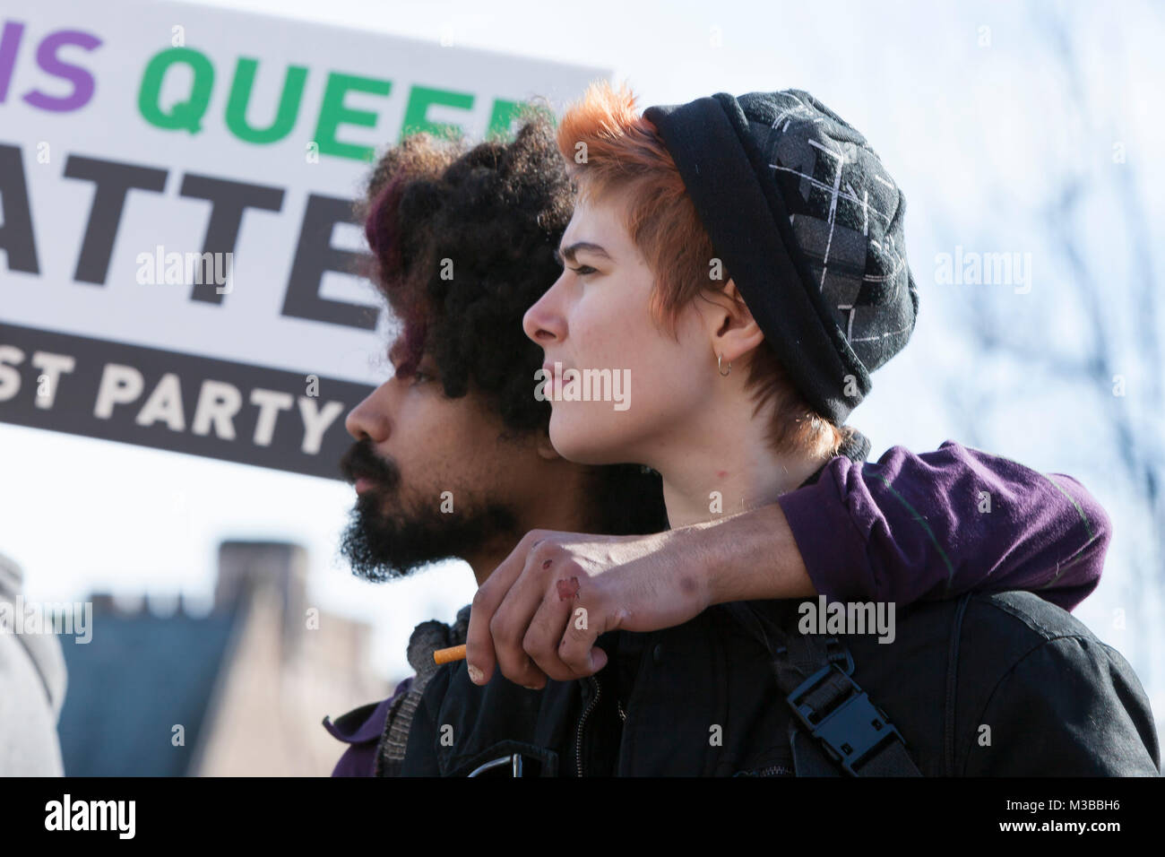Seattle, Washington, USA. 10th February, 2018. A young couple watches the student-led counter-protest of Patriot Prayer's Freedom Rally at the University of Washington. The UW International Socialist Organization and at least dozen other UW clubs organized the counter-protest, dwarfing the Freedom Rally. Founded by Japanese-American activist Joey Gibson, the controversial conservative group, Patriot Prayer, advocates in favor of free speech and opposes big government. Credit: Paul Christian Gordon/Alamy Live News Stock Photo