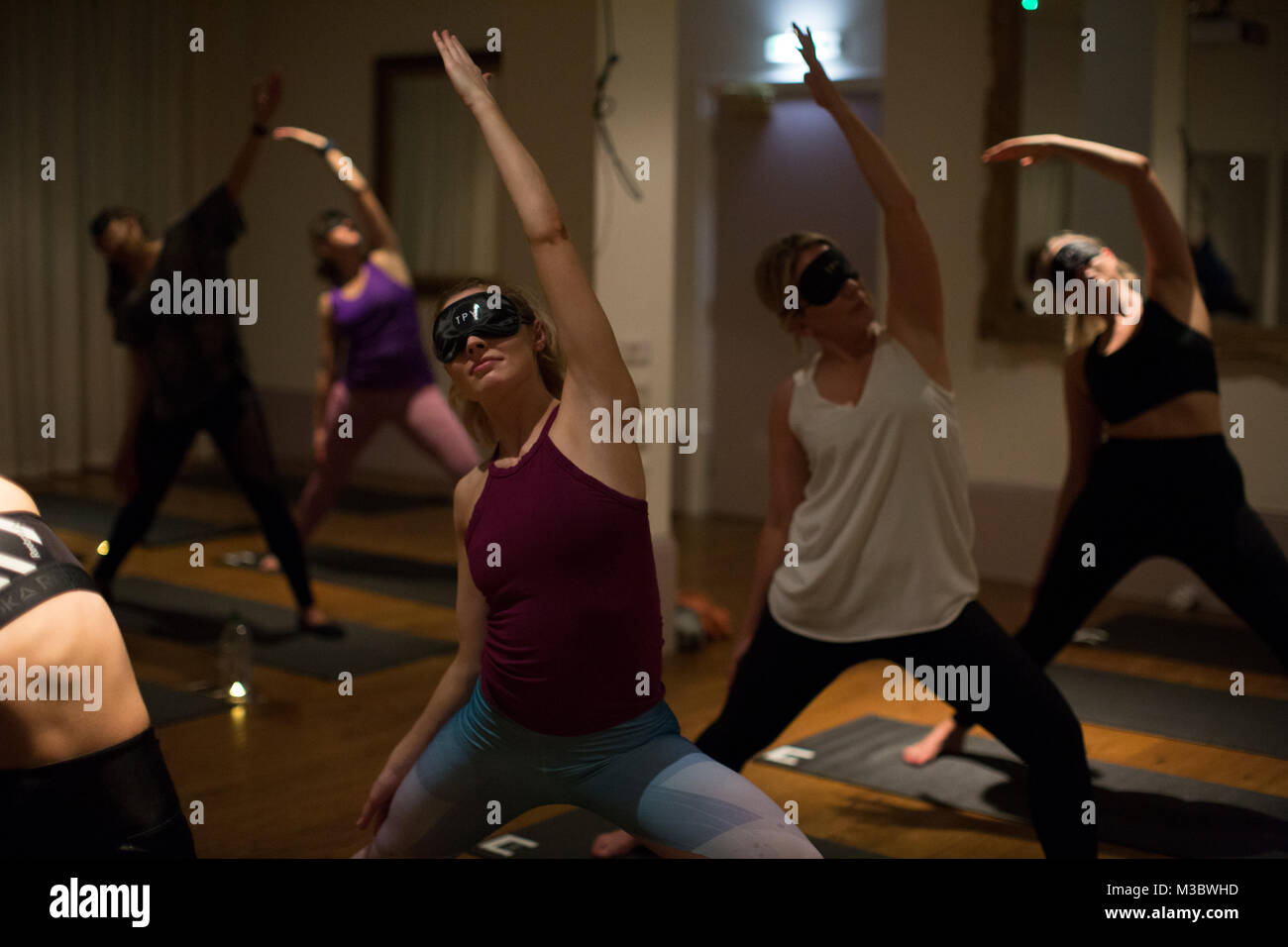 Blindfolded yoga class, London, England UK Stock Photo