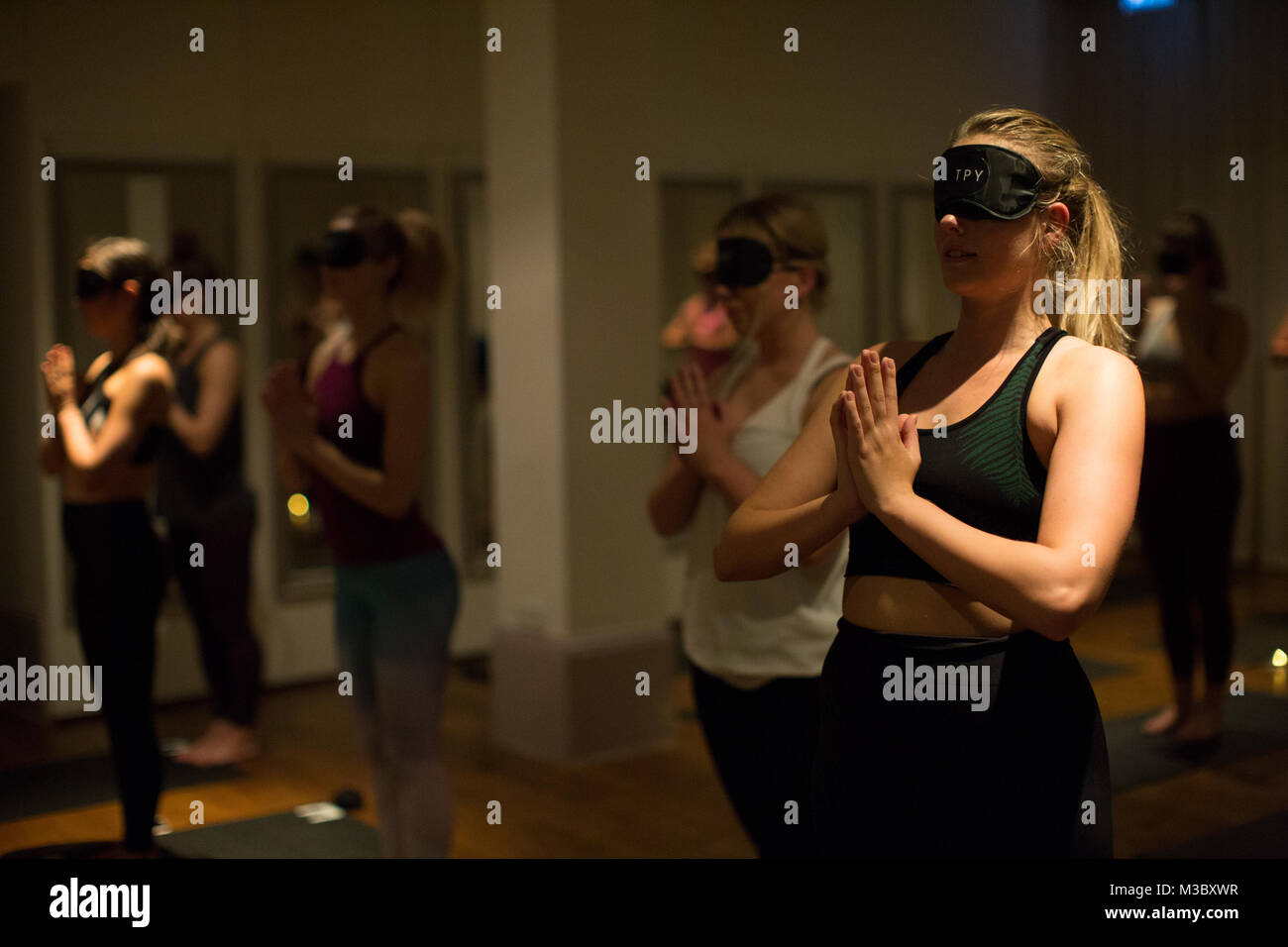 Blindfolded yoga class, London, England UK Stock Photo