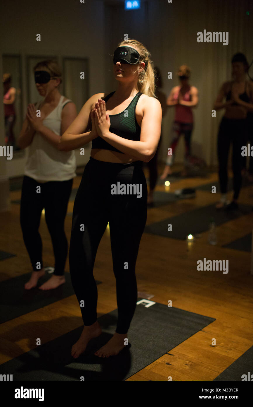 Blindfolded yoga class, London, England UK Stock Photo