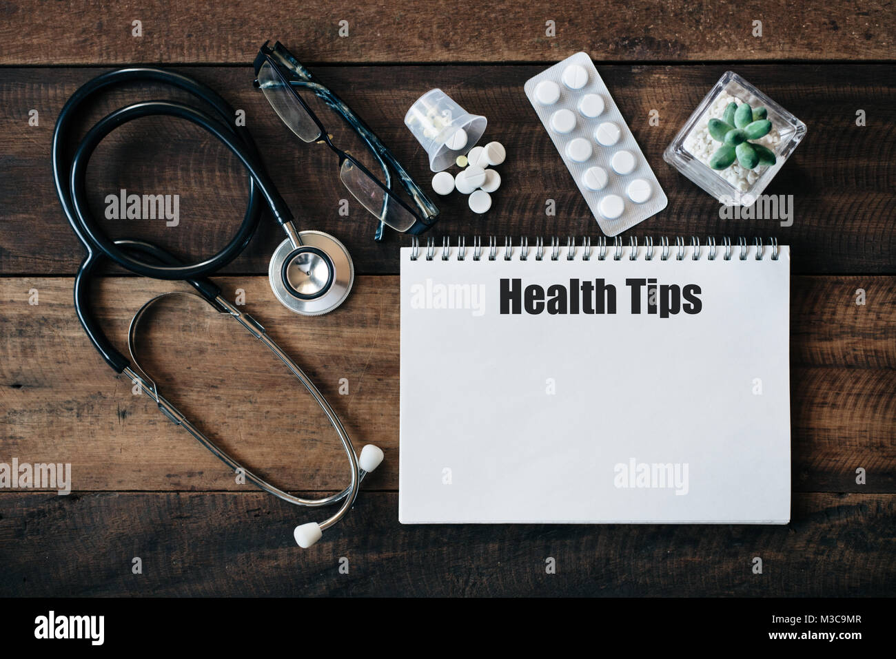 Stethoscope, eyeglass, medicine and notebook with HEALTH TIPS word. medical health concept Stock Photo