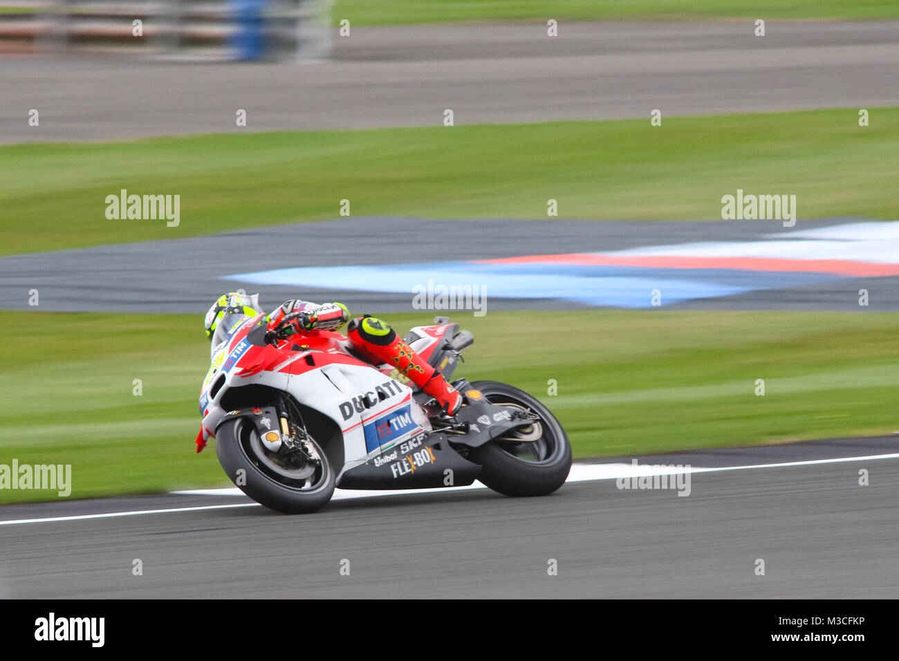 Andrea Iannone exiting Beckets corner and winding up for the Hanger straight during Friday Free Practice at the MotoGP British Grand Prix 2016 Stock Photo