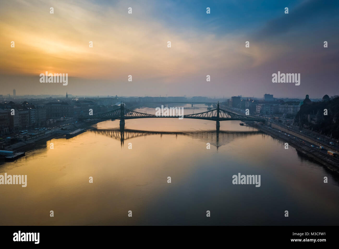 Budapest, Hungary - Aerial panoramic skyline view of Liberty Bridge over River Danube at sunrise with beautiful sky and clouds Stock Photo