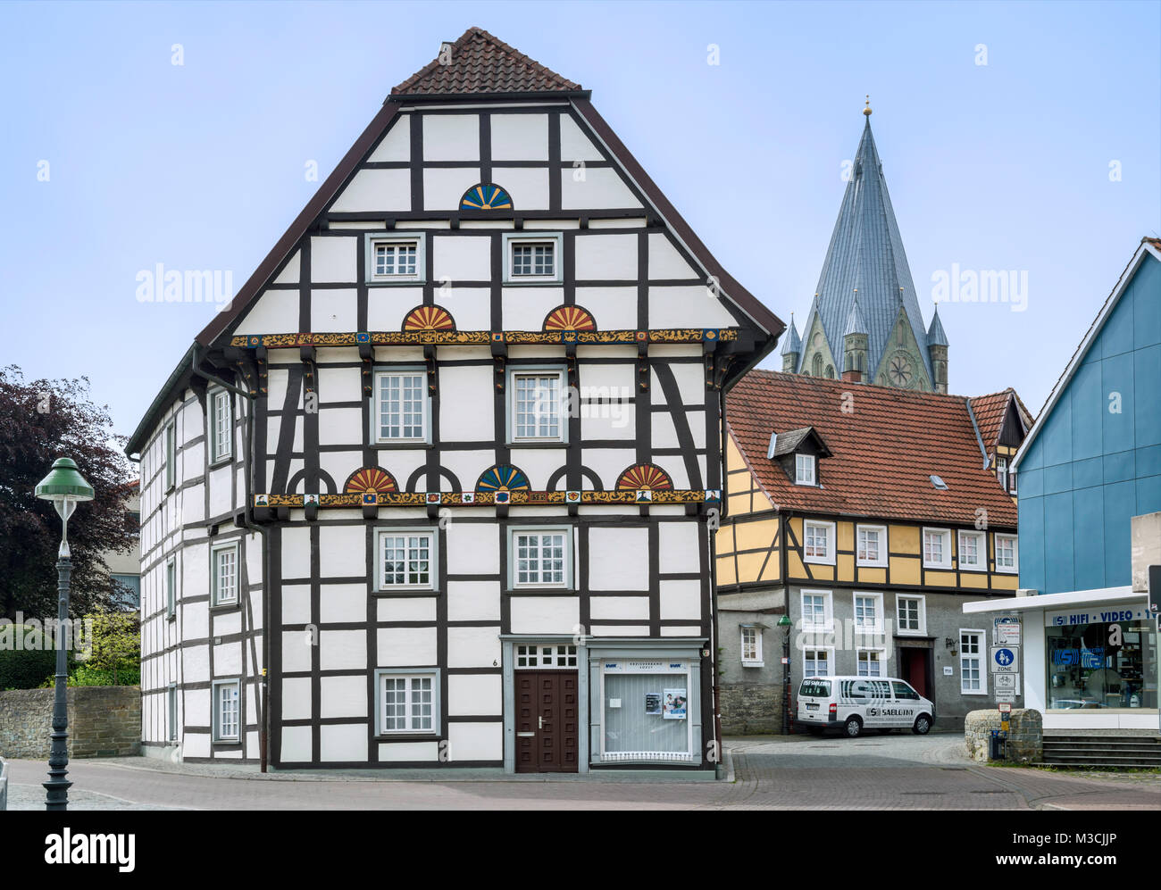 Half-timbered house, 16th century, at Wiesenstrasse, tower of St Patroclus Church, in Soest, Ostwestfalen Region, North Rhine-Westphalia, Germany Stock Photo
