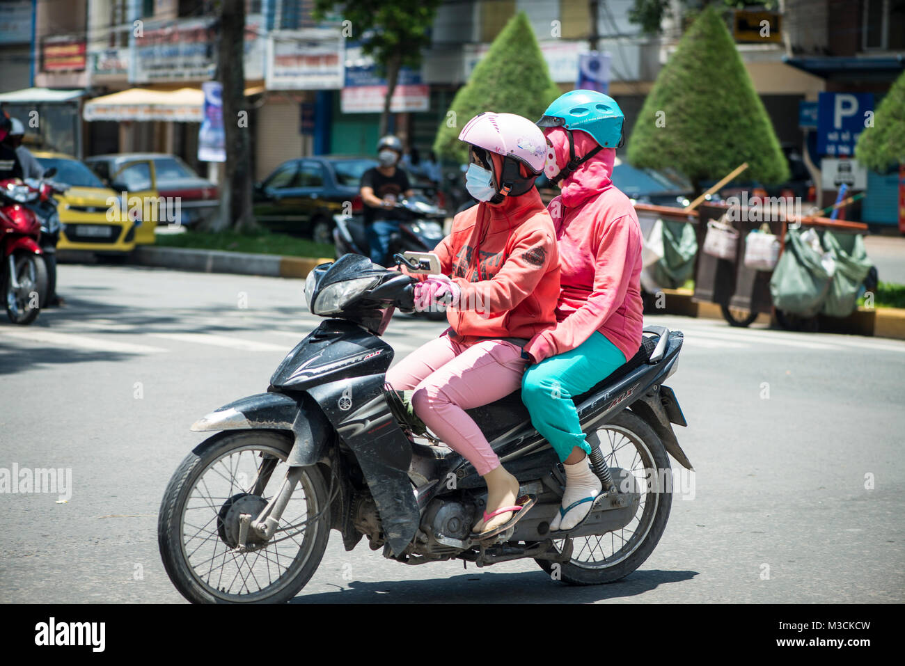Two women on a motorcycle, Vietnam Stock Photo