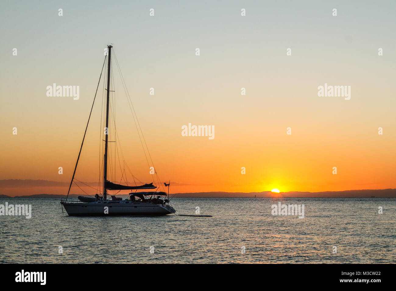 Silhouette of yacht at sunset at Moreton Bay, Queensland, Australia Stock Photo