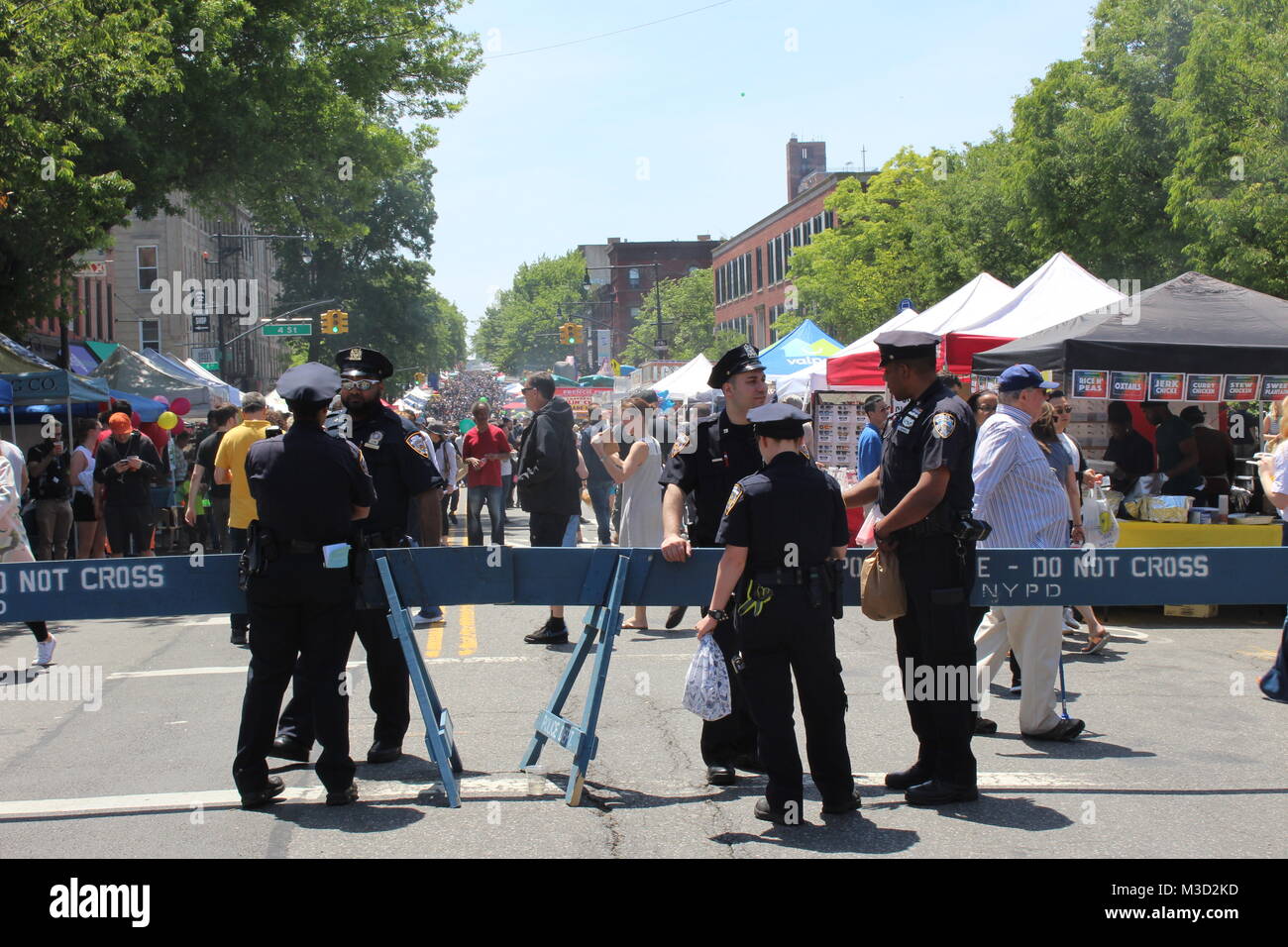 cops form the NYPD new york police department relax at a street fair in