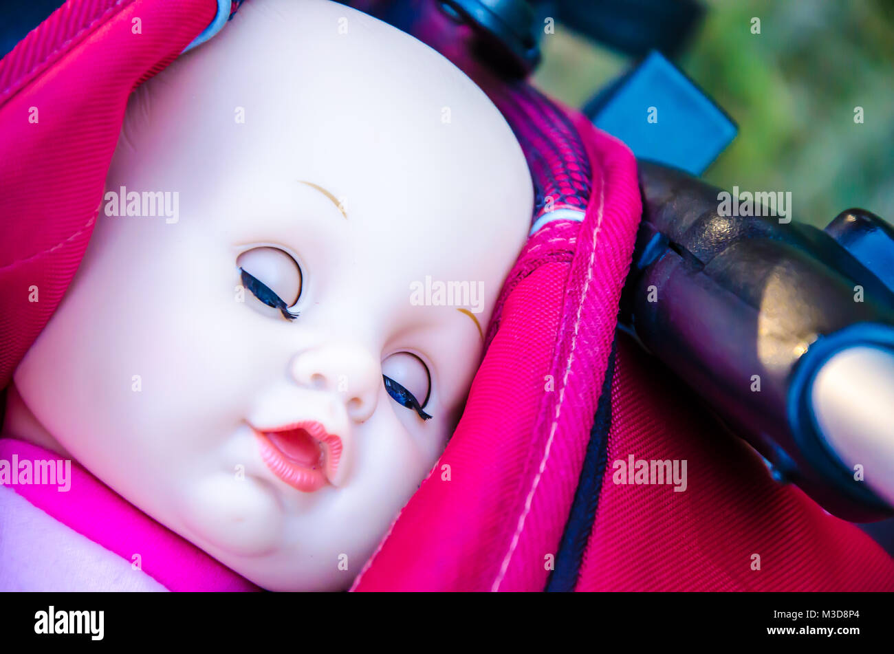 Close-up view of face doll with eyes closed in pram Stock Photo