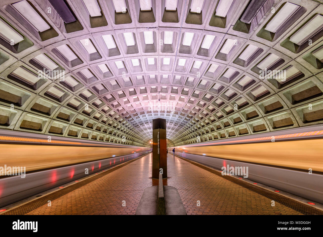 WASHINGTON, D.C. - APRIL 10, 2015: Trains and passengers in a Metro Station. Opened in 1976, the Washington Metro is now the second-busiest rapid tran Stock Photo