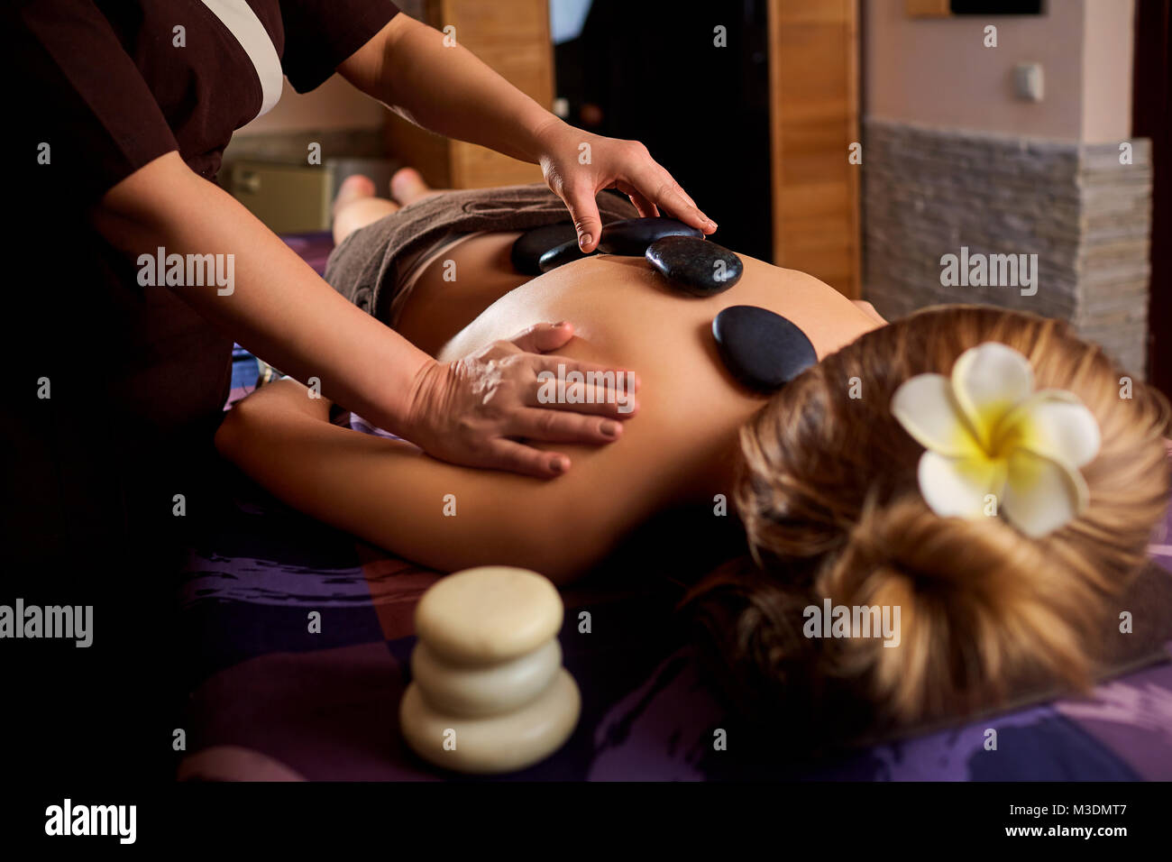 Stone massage back spa for a woman. Stock Photo