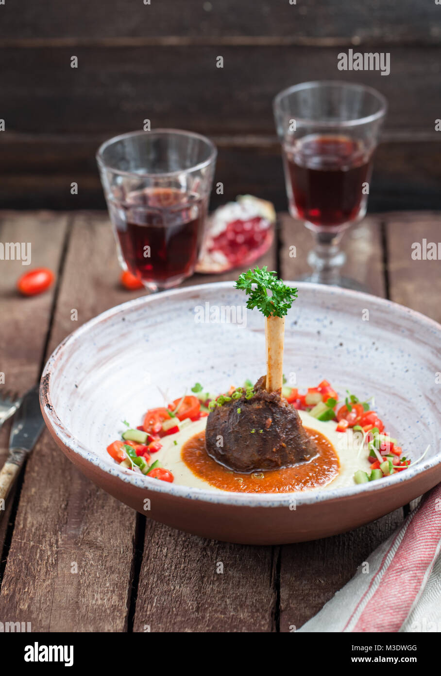 Lamb shank with eggplant puree and fresh vegs, traditional turkish dish Stock Photo