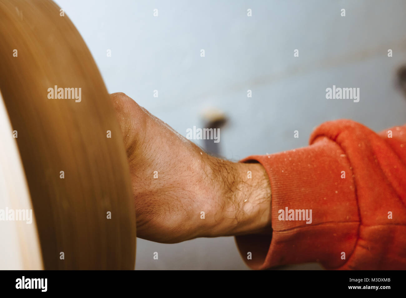 Wood turners using sandpaper polished wood on a lathe Stock Photo Alamy