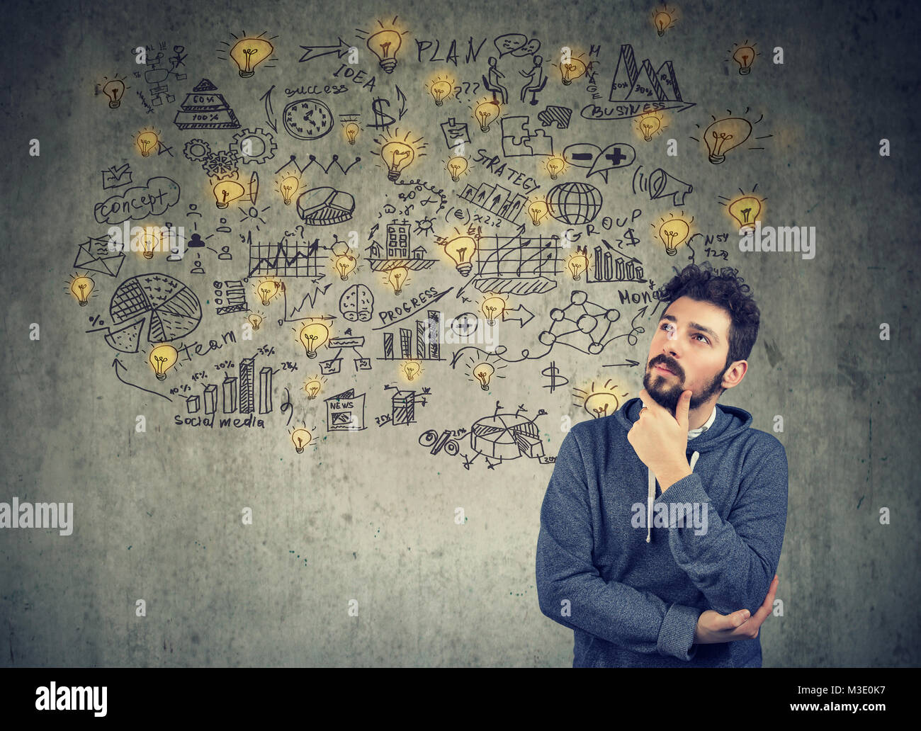 Creative young man thinking of business plan to become successful. Stock Photo