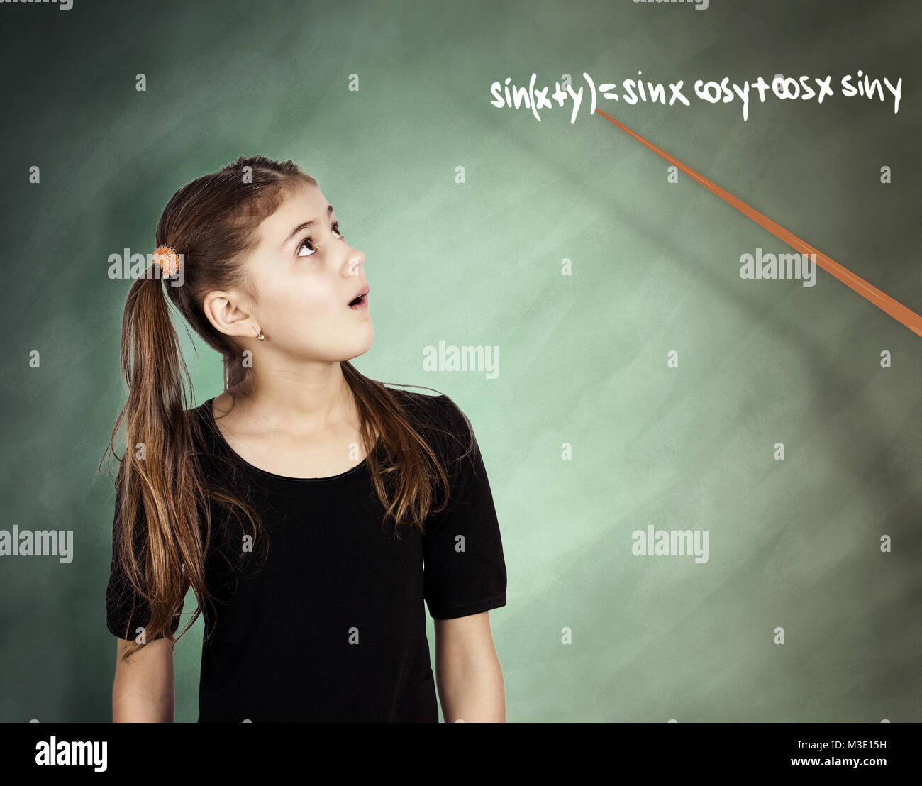 Little girl looking amazing while studying math in class understanding ...