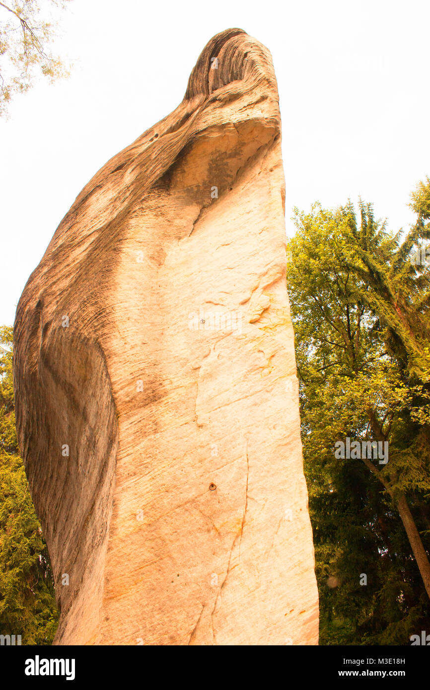 In the foreground is sculpture from rock. Right and background trees. Stock Photo