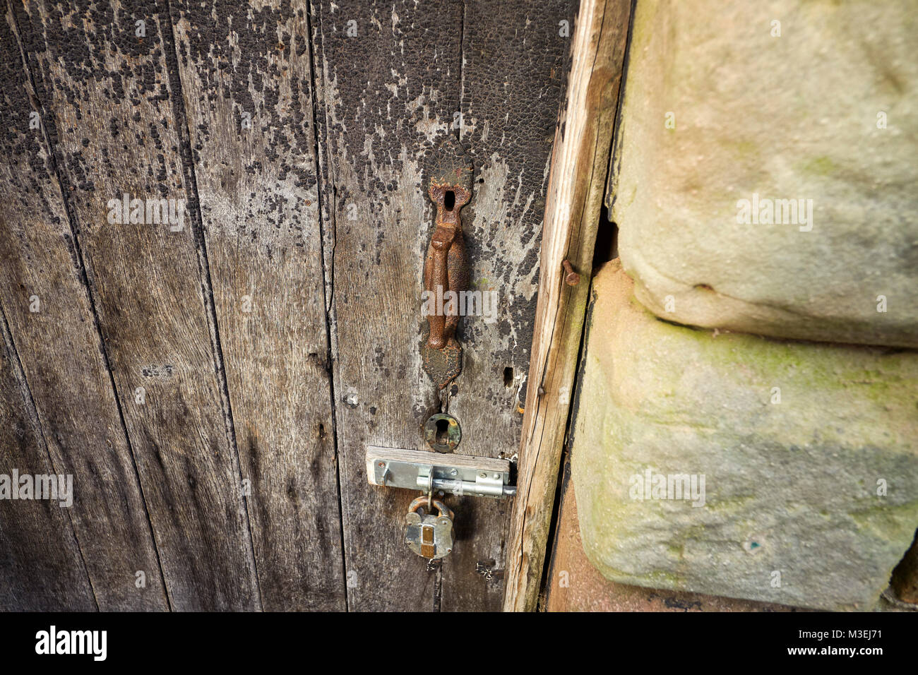 Iron latch and handle on an old door Stock Photo