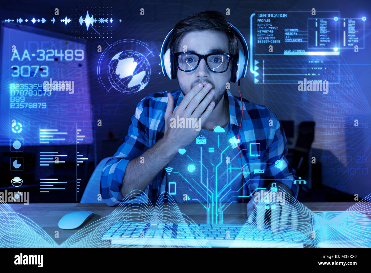 Surprised young programmer looking at the screen and closing his mouth ...