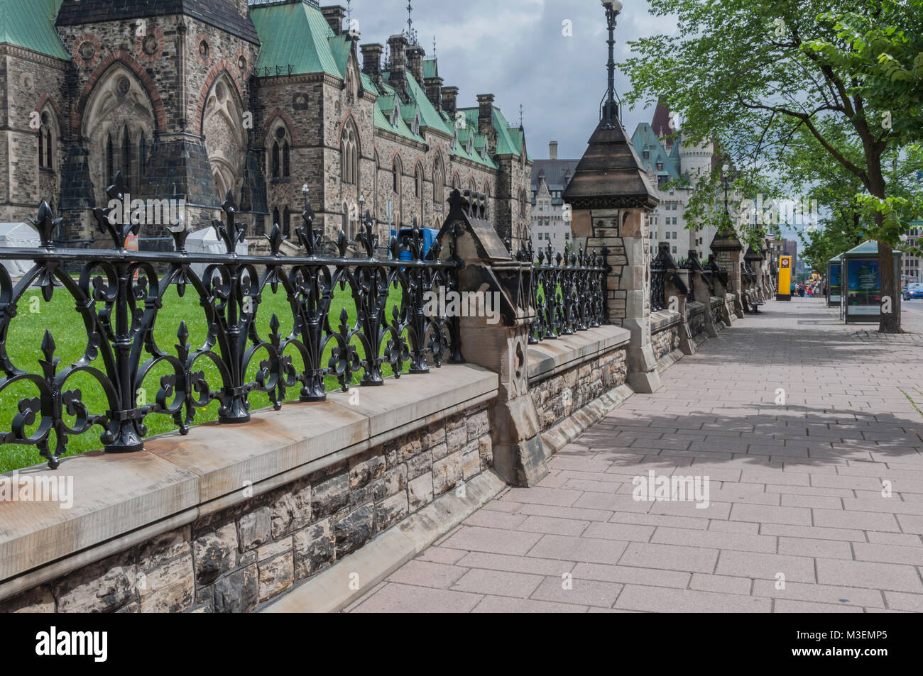 Sidewalk in Ottawa, Ontario Canada with black wrought iron fence above