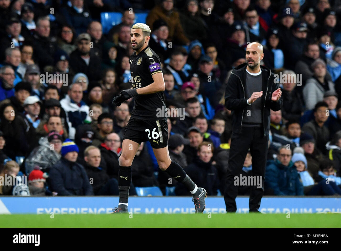 Leicester City's Riyad Mahrez (left) and Manchester City manager Pep Guardiola during the Premier League match at the Etihad Stadium, Manchester. Stock Photo