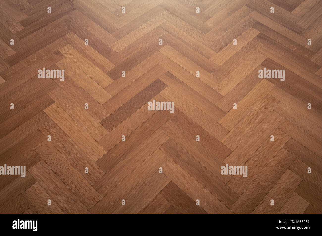 dark parquet floor, wooden floor - parquet flooring herringbone Stock Photo