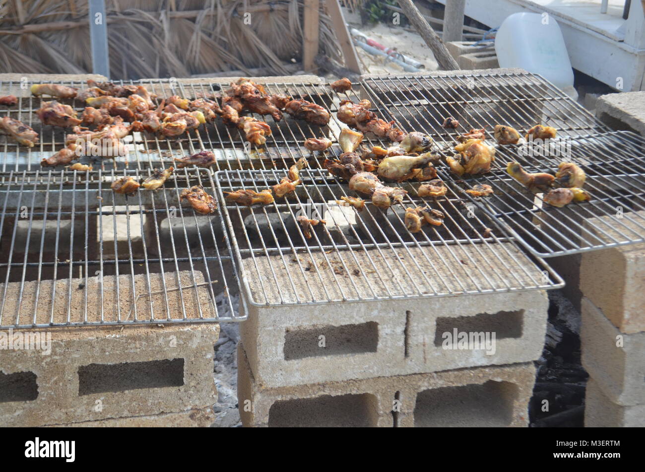 Makeshift outdoor grill on a beach in Cayo Coco, Cuba. Chicken legs being  cooked on a barbecue Stock Photo - Alamy