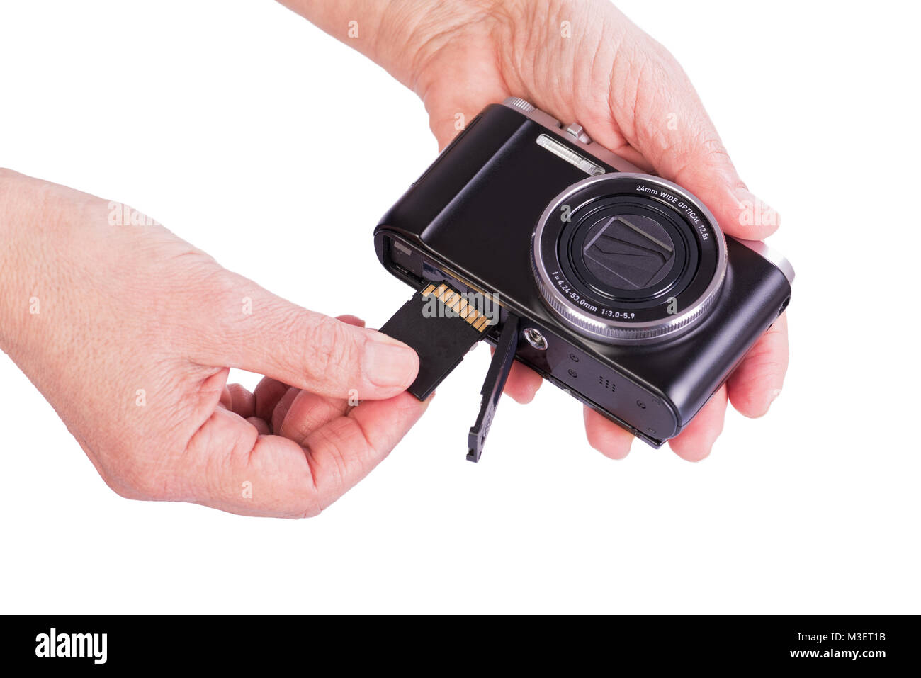 Insert memory card into the camera. Woman's hands on a white background. Stock Photo