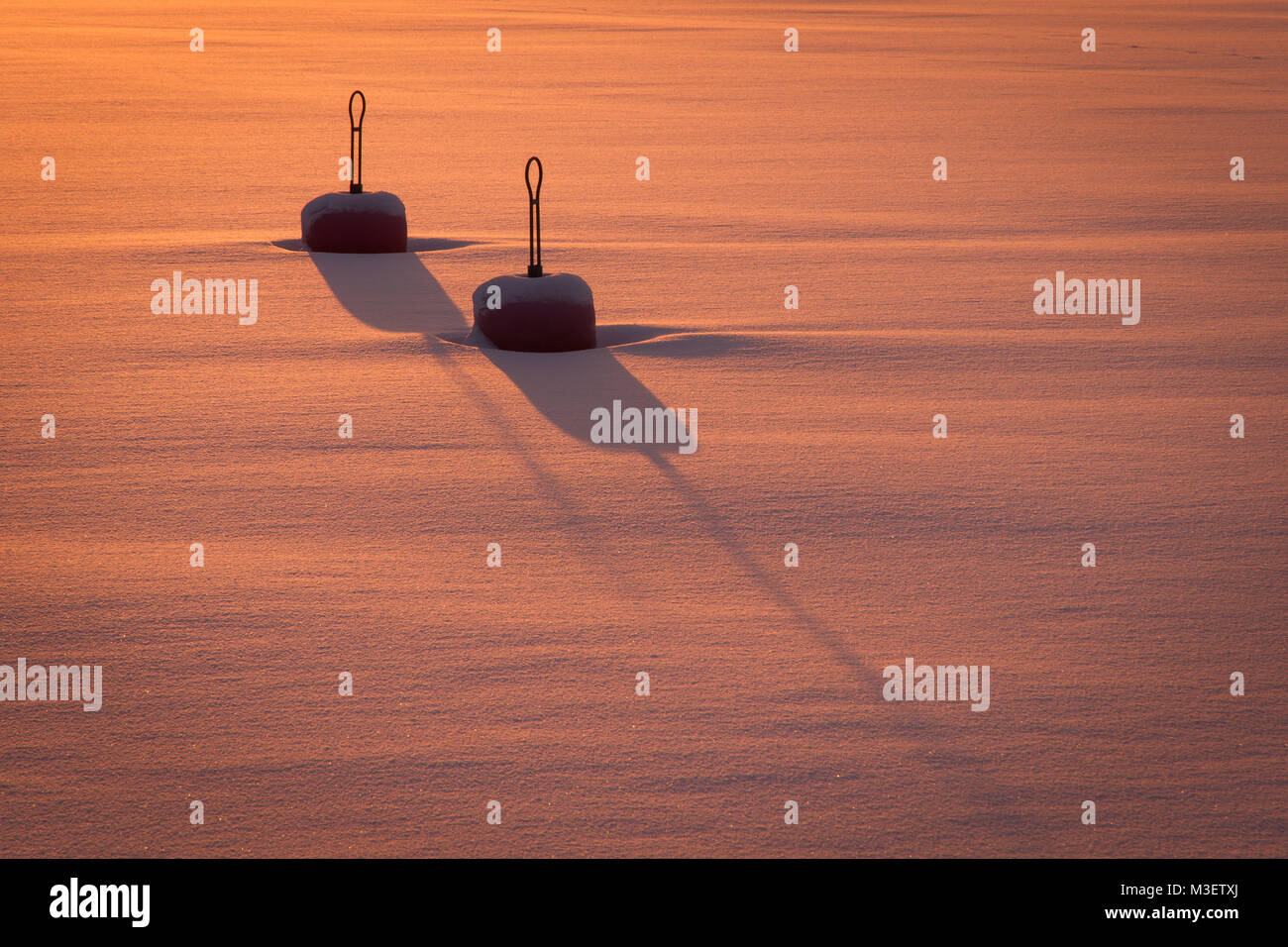 Winter image with two buoys in the frozen ocean. Stock Photo
