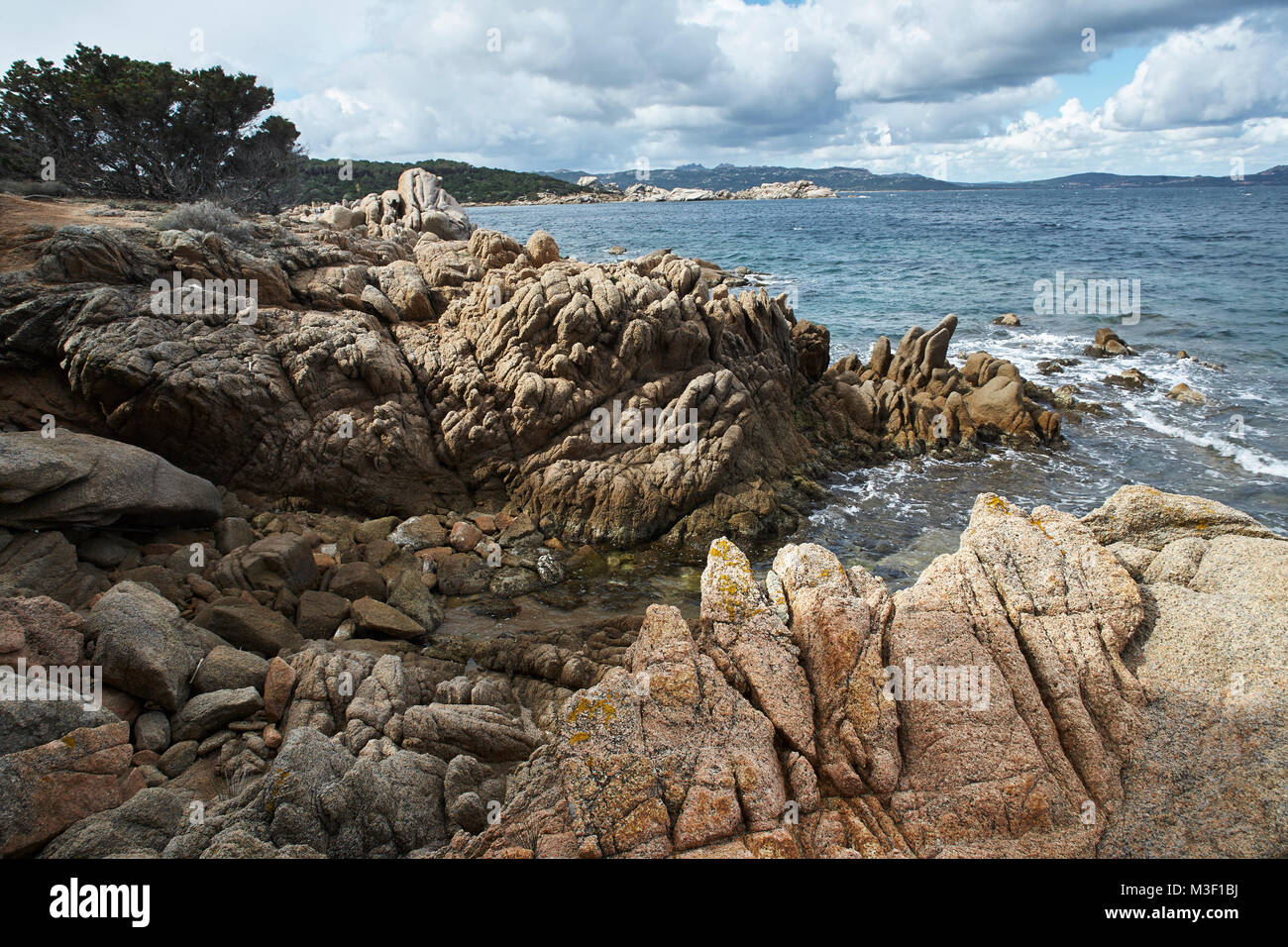 Sardinian Remarkable Rocks Climbing the distinctive rocks along the coastline of Sardinia Stock ...