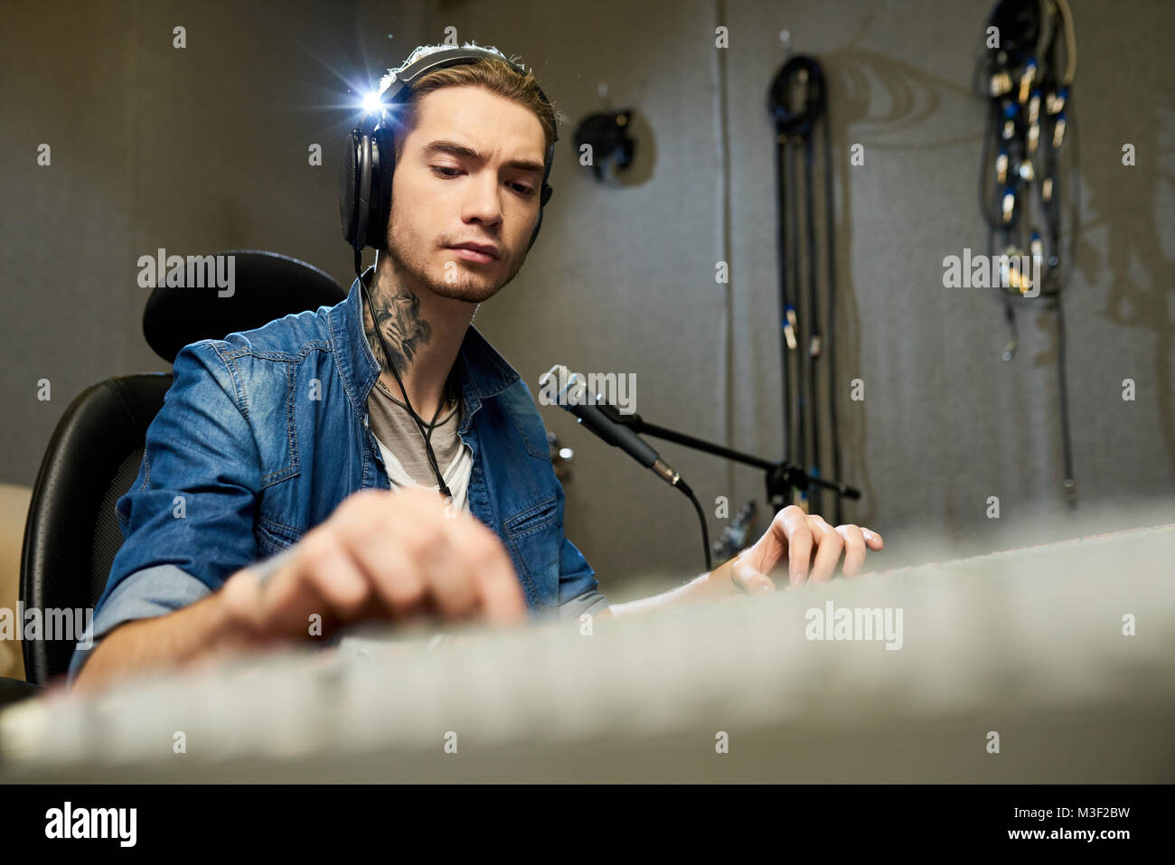 Concentrated music engineer working on sound mixer Stock Photo Alamy