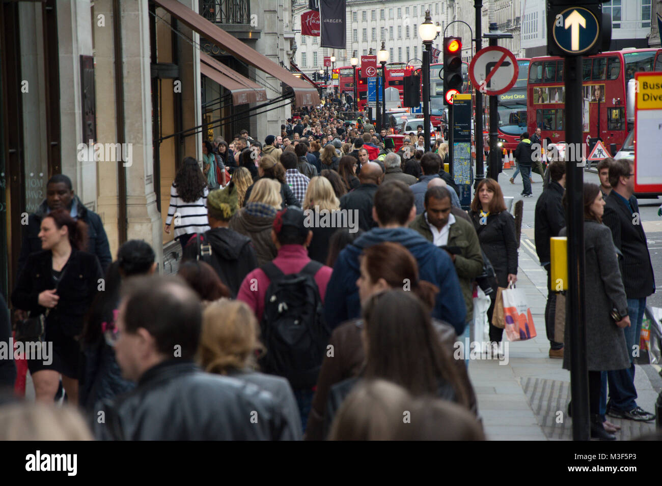 LONDON, UK- APRIL 5, 2014: People walking down the street in crowded London Stock Photo
