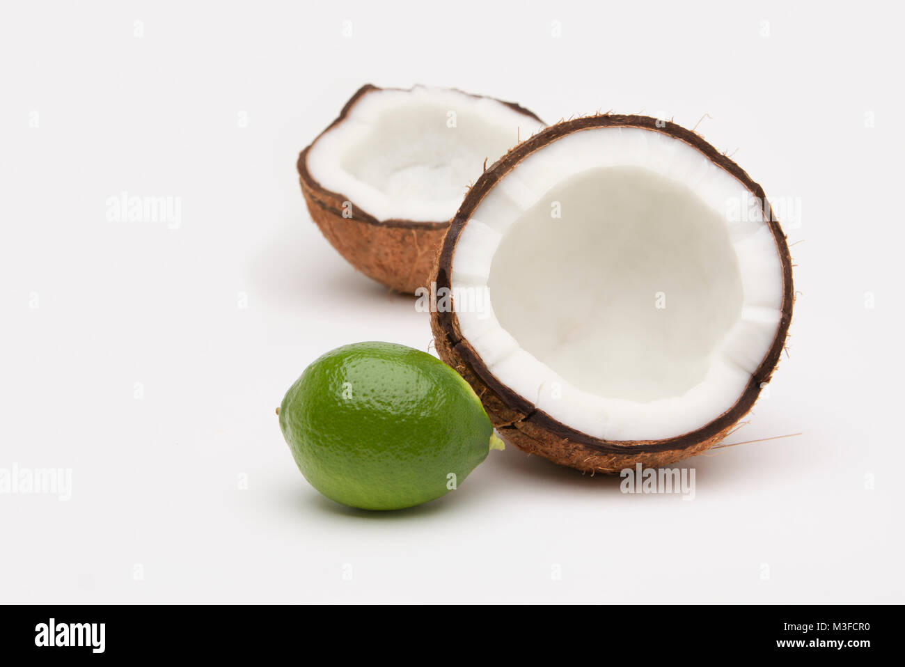 Lime and coconut isolated on white Stock Photo - Alamy