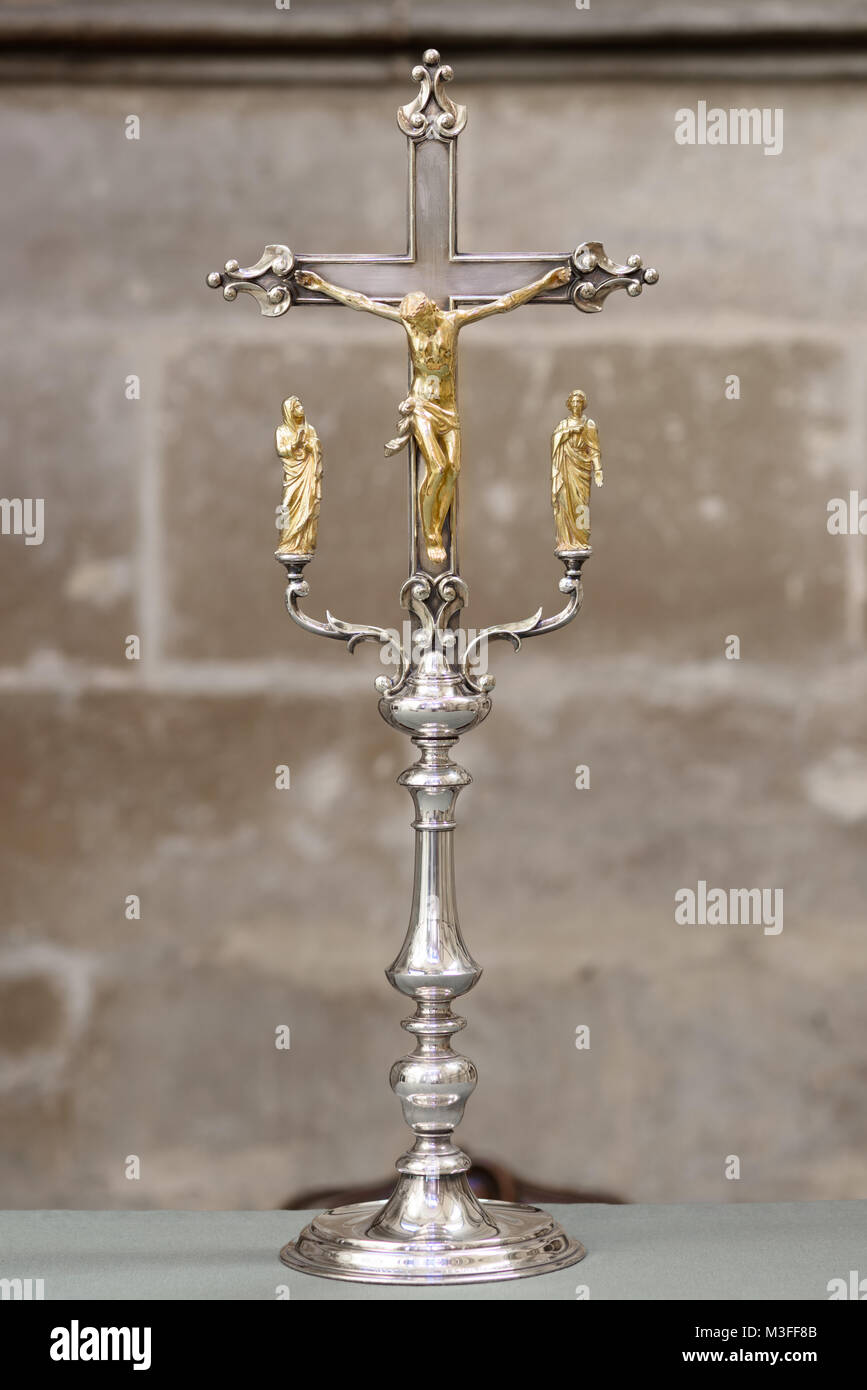 Gilded silver crucifix on an altar in a sided chapel, an example of a religious artifact at the medieval cathedral of Lincoln, England. Stock Photo