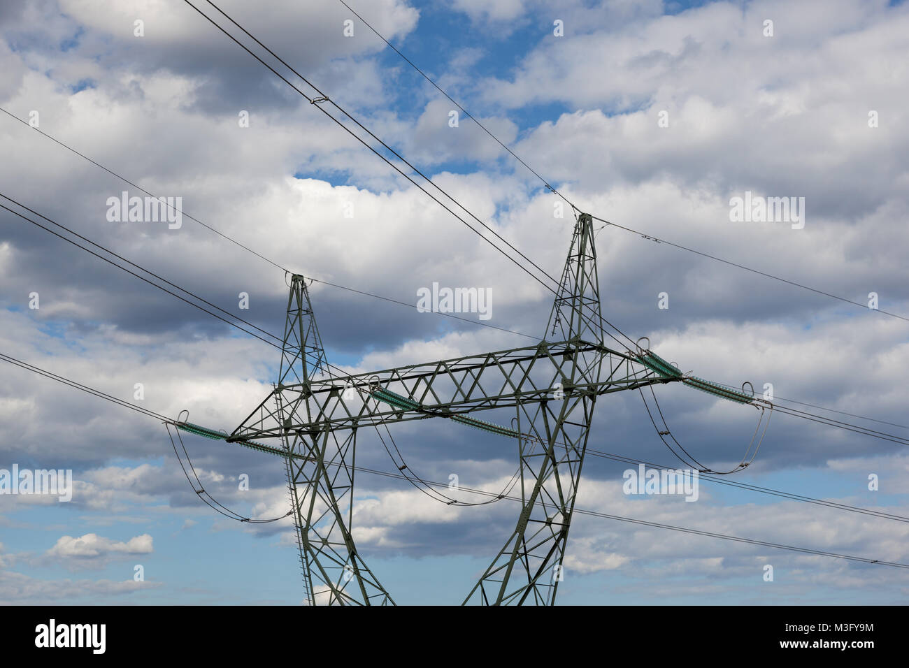 Electricity pylon against cloudy skyrn Stock Photo