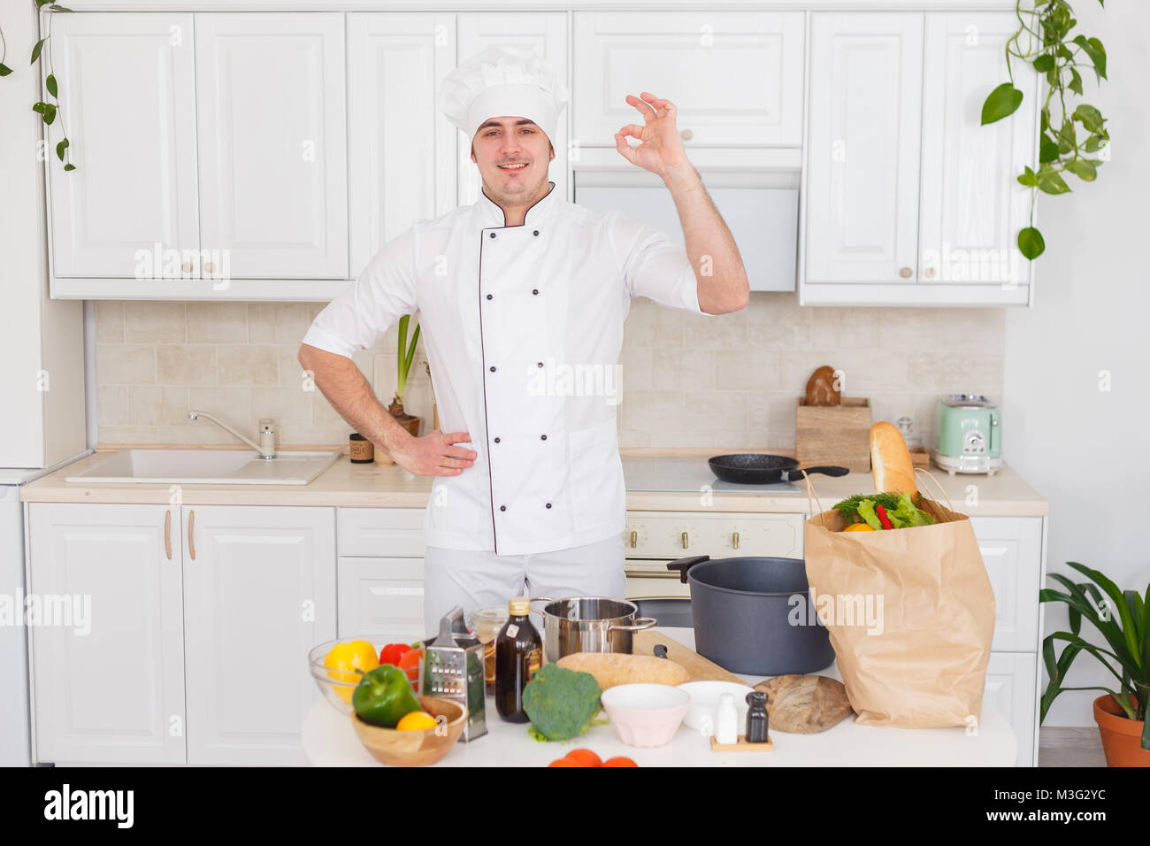 Smiling chef cooking a vegetable stew Stock Photo - Alamy