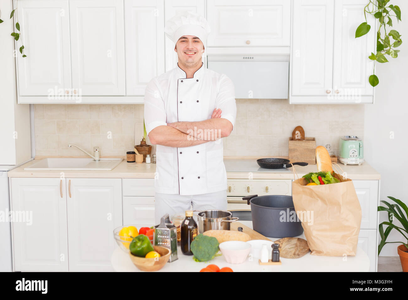 Smiling chef cooking a vegetable stew Stock Photo Alamy