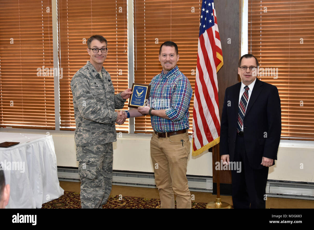 Col. Scott Cain, Arnold Engineering Development Complex commander, and Dr. Mark Mehalic, Arnold Engineering Development Complex vice director, presents Mr. Paul Wright, AEDC/TSDIC, with a plaque for APF Cat III Civilian of the Quarter, January 25, 2018 at the Arnold Lakeside Club. Stock Photo