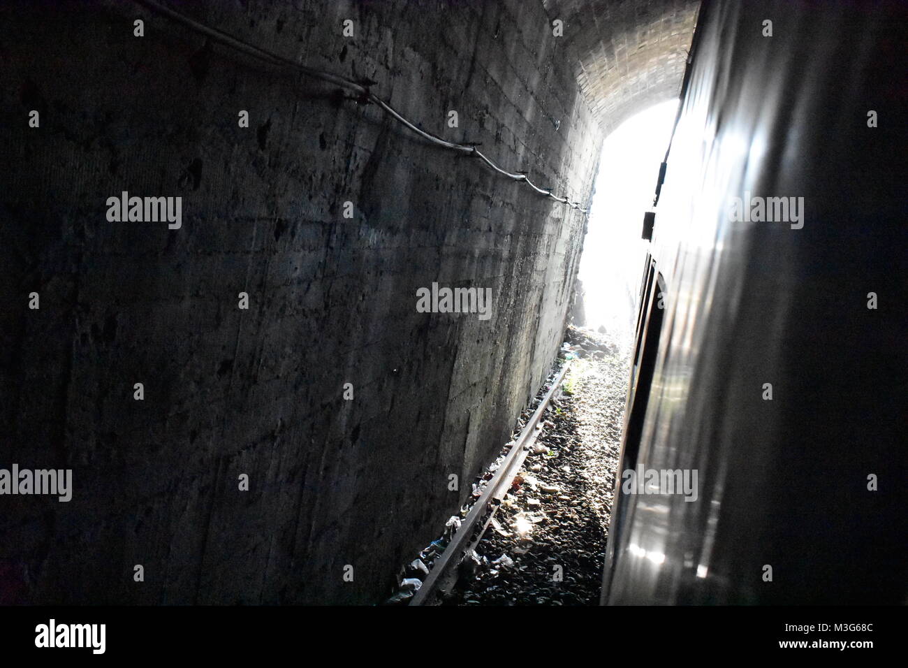 train running at Tunnel & sun Light glowing. Stock Photo
