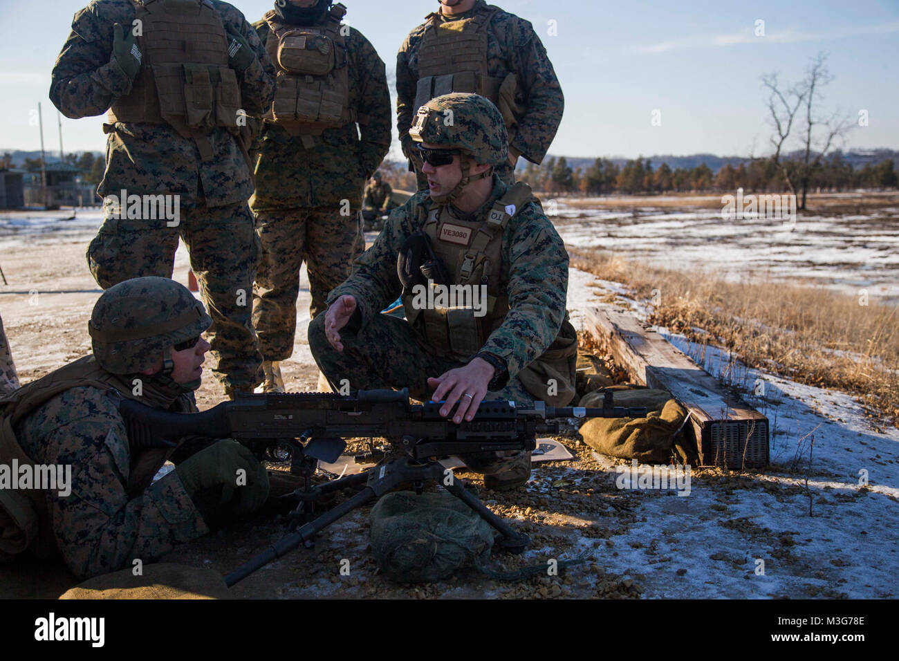 U.S. Marine Corps 1st Lt. Robert Verrall, an electronic warfare officer with Marine Unmanned Aerial Vehicle Squadron (VMU) 2, instructs Marines on weapons conditions for the M240B machine gun for a machine gun range during Frozen Badger on Fort McCoy, Wis., Jan. 26, 2018. Frozen Badger is a training exercise designed to improve VMU-2's operational capabilities in extreme cold weather environments. (U.S. Marine Corps Stock Photo