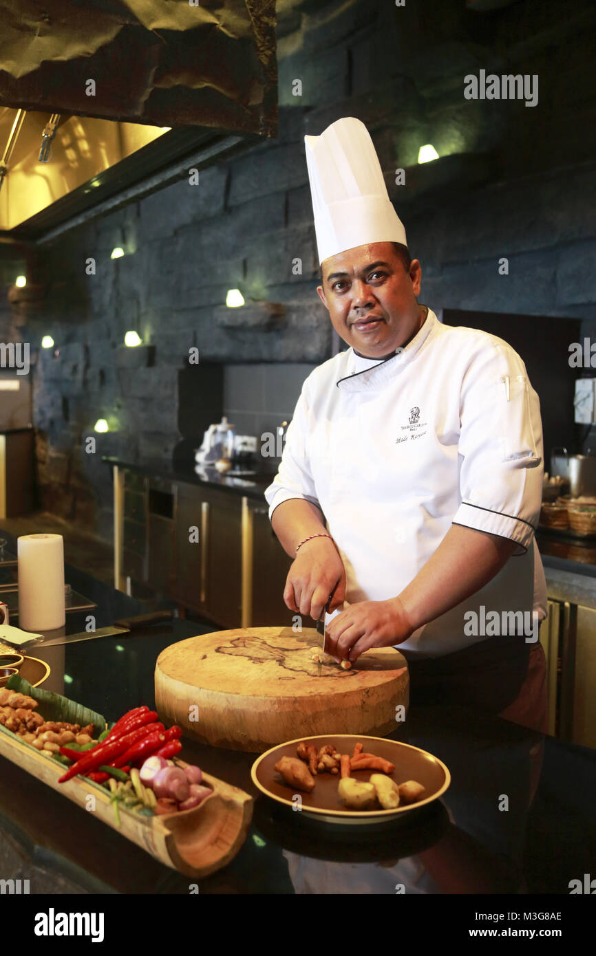 A chef preparing Indonesian cuisine in his kitchen in the RitzCarlton