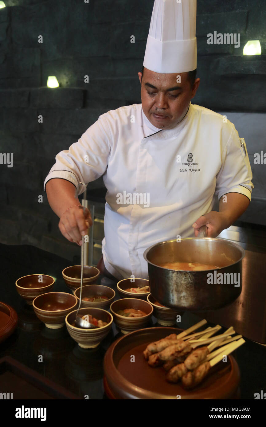 A chef preparing Indonesian cuisine in his kitchen in the RitzCarlton