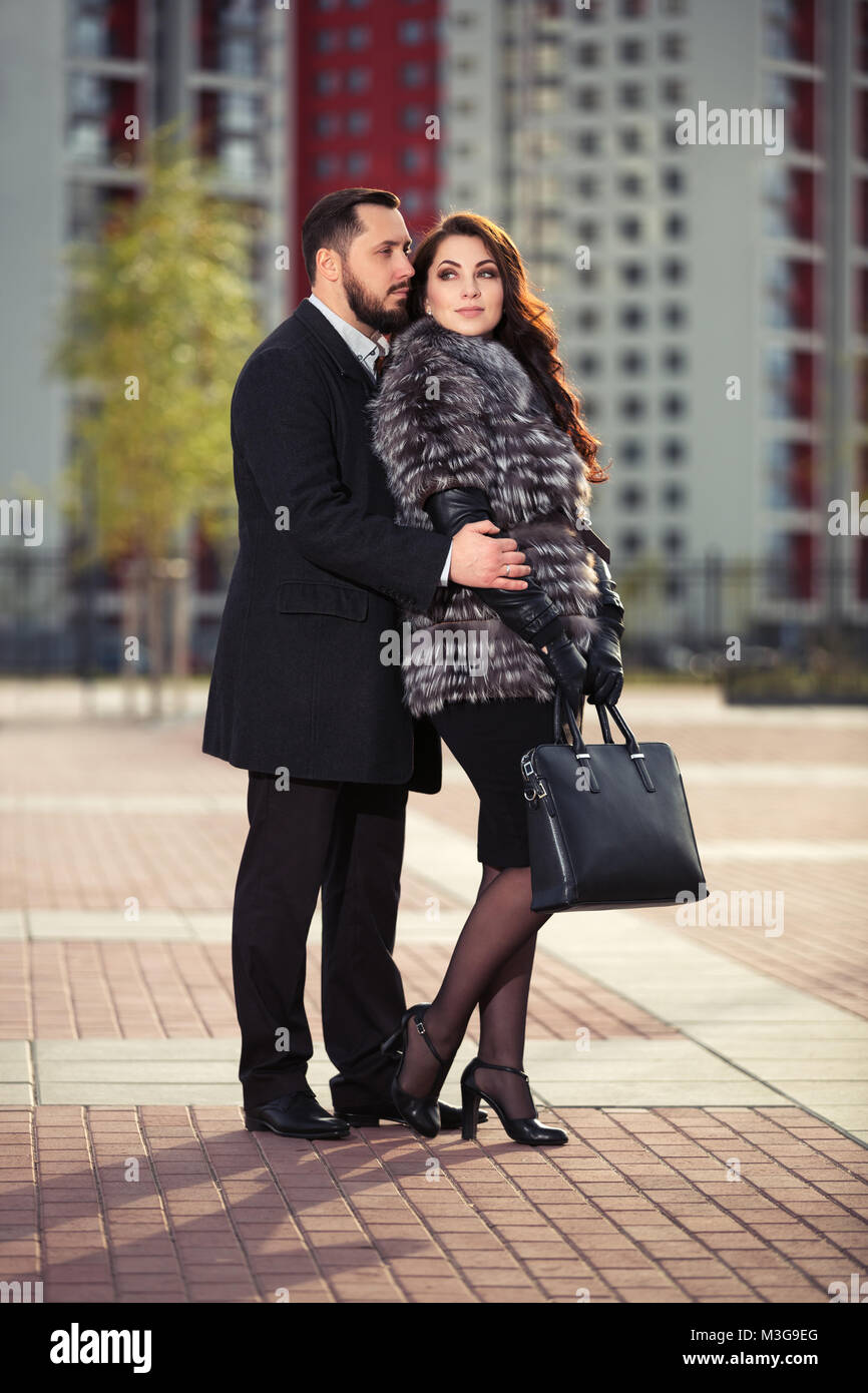 Happy young fashion couple in love walking on city street Stock Photo