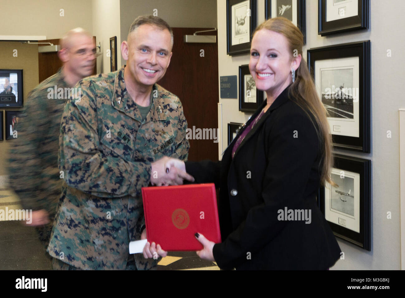 Jennifer Merlo, the Single Marine Program (SMP) coordinator for Marine Corps Air Station Cherry Point, receives a Certificate of Commendation from U.S. Marine Corps Maj. Gen. Matthew G. Glavy, the commanding general of 2nd Marine Aircraft Wing, at MCAS Cherry Point, N.C., Jan. 30, 2018. Merlo helped maintain the best SMP from July 2013 to Dec. 2017 and accumulated the highest number of volunteers and volunteer hours in 2017. (U.S. Marine Corps Stock Photo