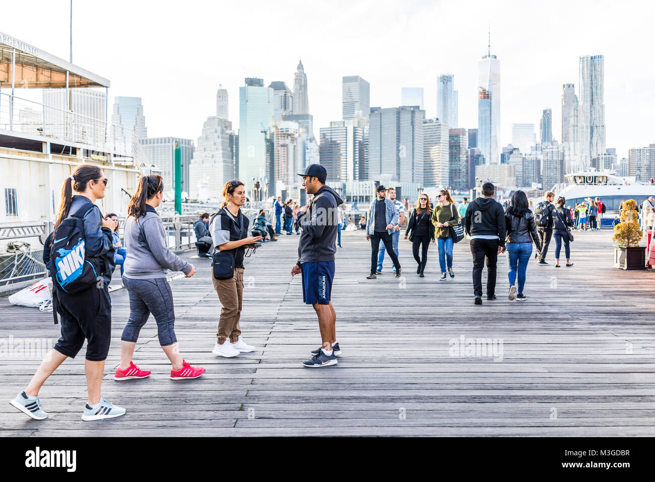 Brooklyn, USA - October 28, 2017: Outside outdoors in NYC New York City Brooklyn Bridge Park with many crowd of people on wooden boardwalk pier dock o Stock Photo