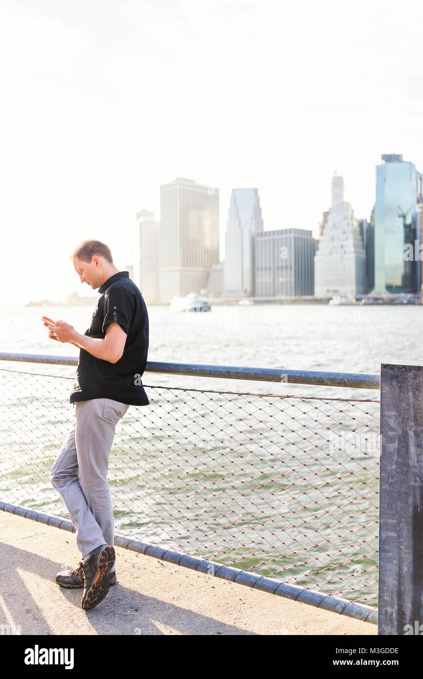 Young man outside outdoors in NYC New York City Brooklyn Bridge Park by