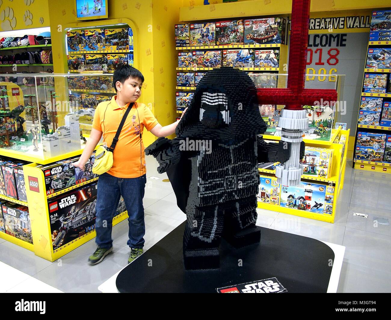 MANDALUYONG CITY, PHILIPPINES - JANUARY 21, 2018: A young boy looks at toys on display at a toy store in a shopping mall. Stock Photo