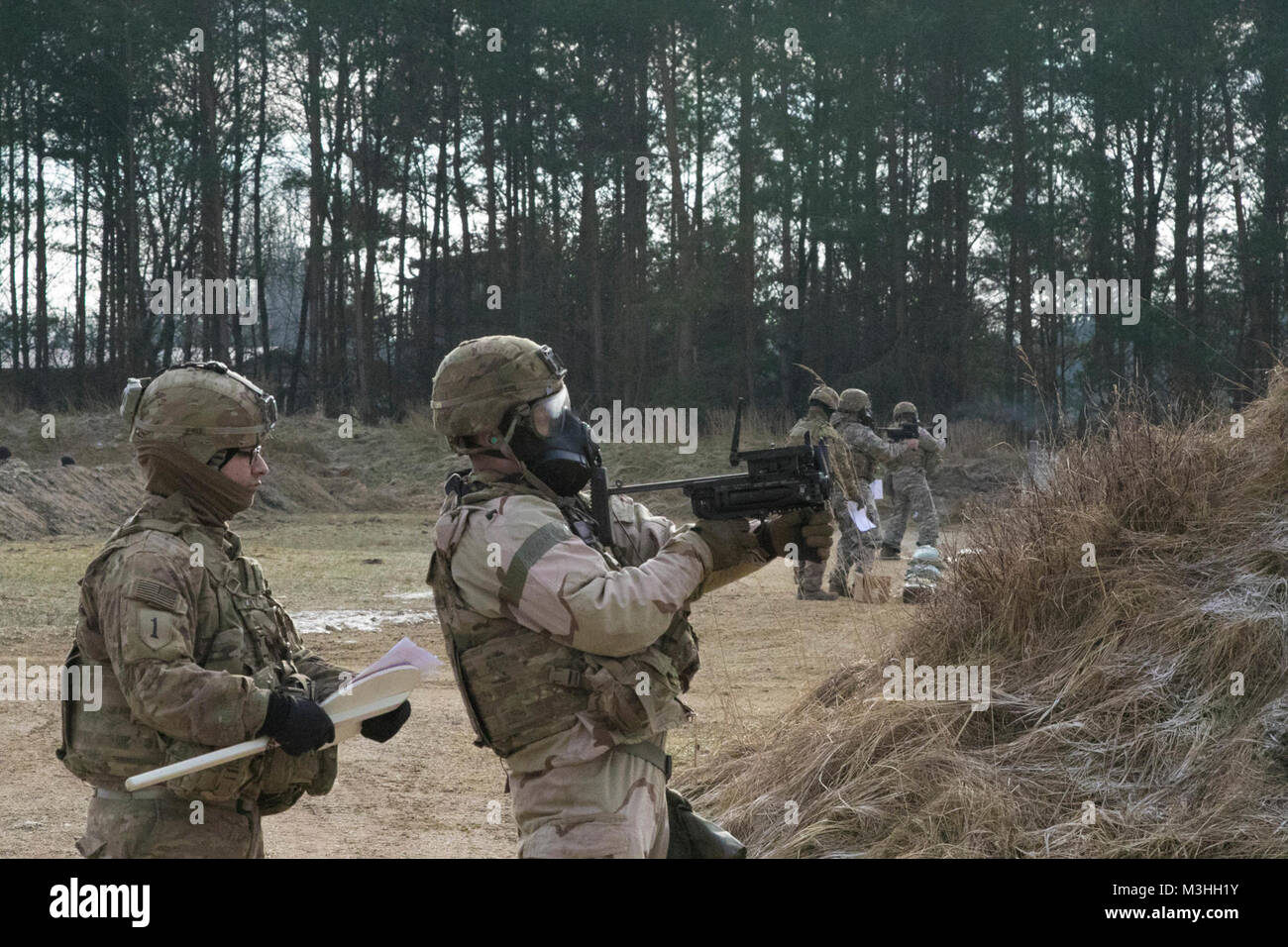 A U.S. Soldier assigned to 5th Squadron, 4th Cavalry Regiment, 2nd Armored Brigade Combat Team, 1st Infantry Division, Fort Riley, Kansas shoots an M320 grenade launcher while wearing equipment designed to protect against chemical and biological threats during training at Grafenwoehr Training Area, Germany, Feb. 6, 2018.  The training with the grenade launcher was part of a training session that included other various tasks, such as familiarization with U.S. military weapons and defense against chemical and biological threats. (U.S. Army Stock Photo