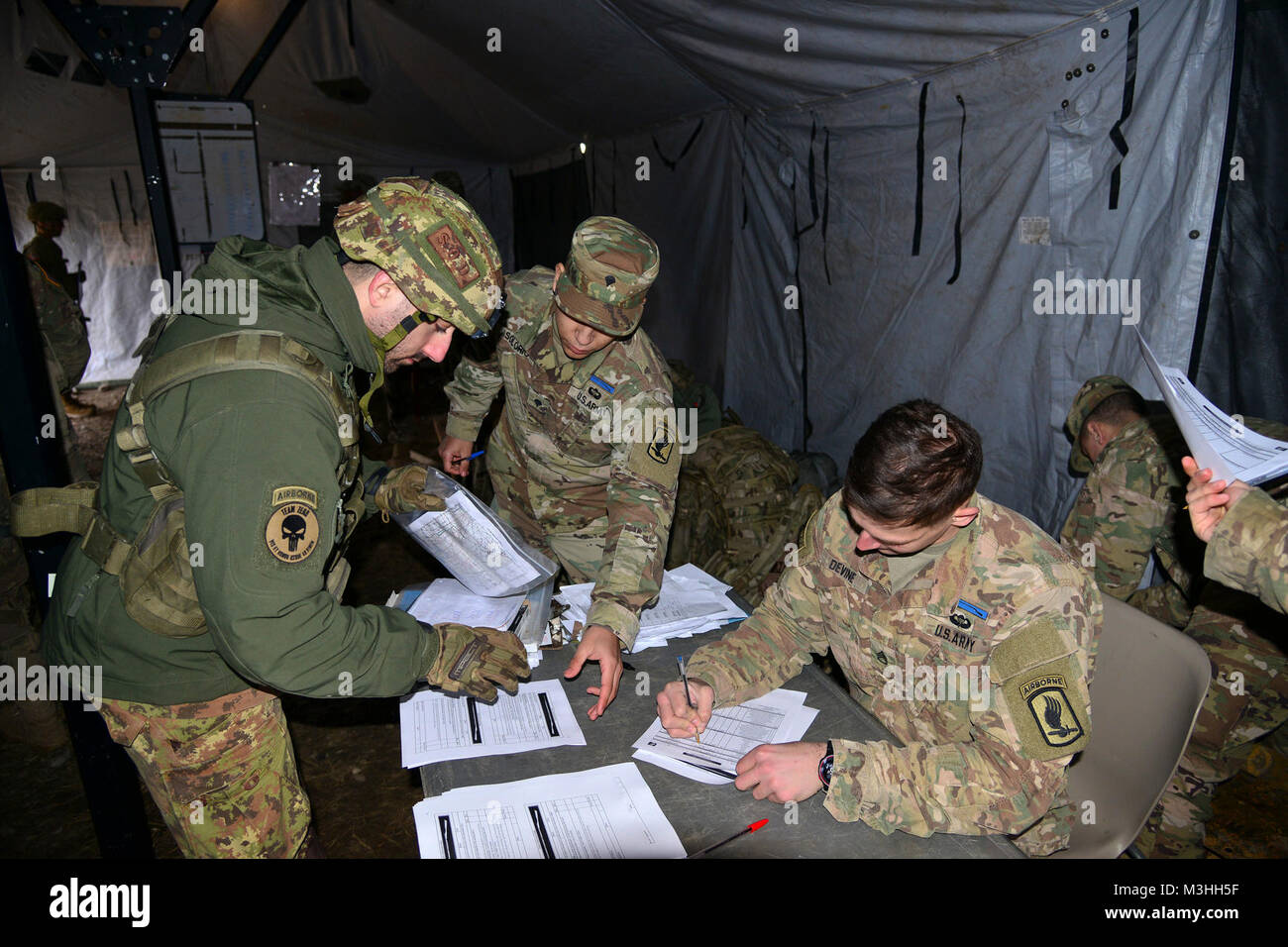A Italian Army Paratrooper from Brigata Folgore, turns in his results during a land navigation for the weeklong testing for the Expert Infantryman Badge. The soldiers must complete a number of prerequisites and pass a battery of graded tests on basic Infantry skills Feb. 6, 2018 at Cellina Meduna area, Pordenone, Italy. (U.S. Army Stock Photo