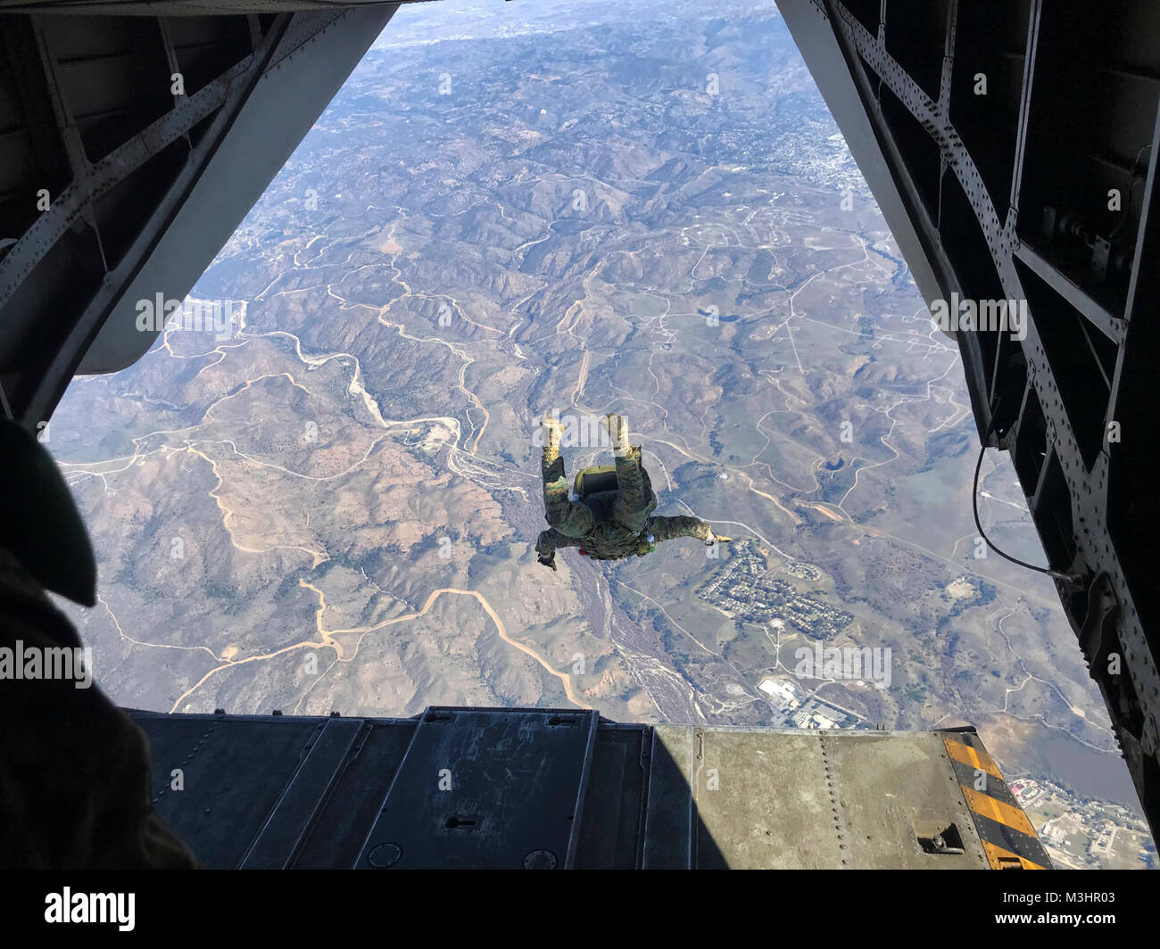 Marines with 1st Marine Reconnaissance Battalion execute a 10,000-foot jump from a CH-53E with Marine Heavy Helicopter Squadron (HMH) 465 over Marine Corps Base Camp Pendleton, Calif., Feb. 6. During parachute and flight operations, the ground combat element and the air combat element work together to ensure safety and mission accomplishment during training. (U.S. Marine Corps Stock Photo