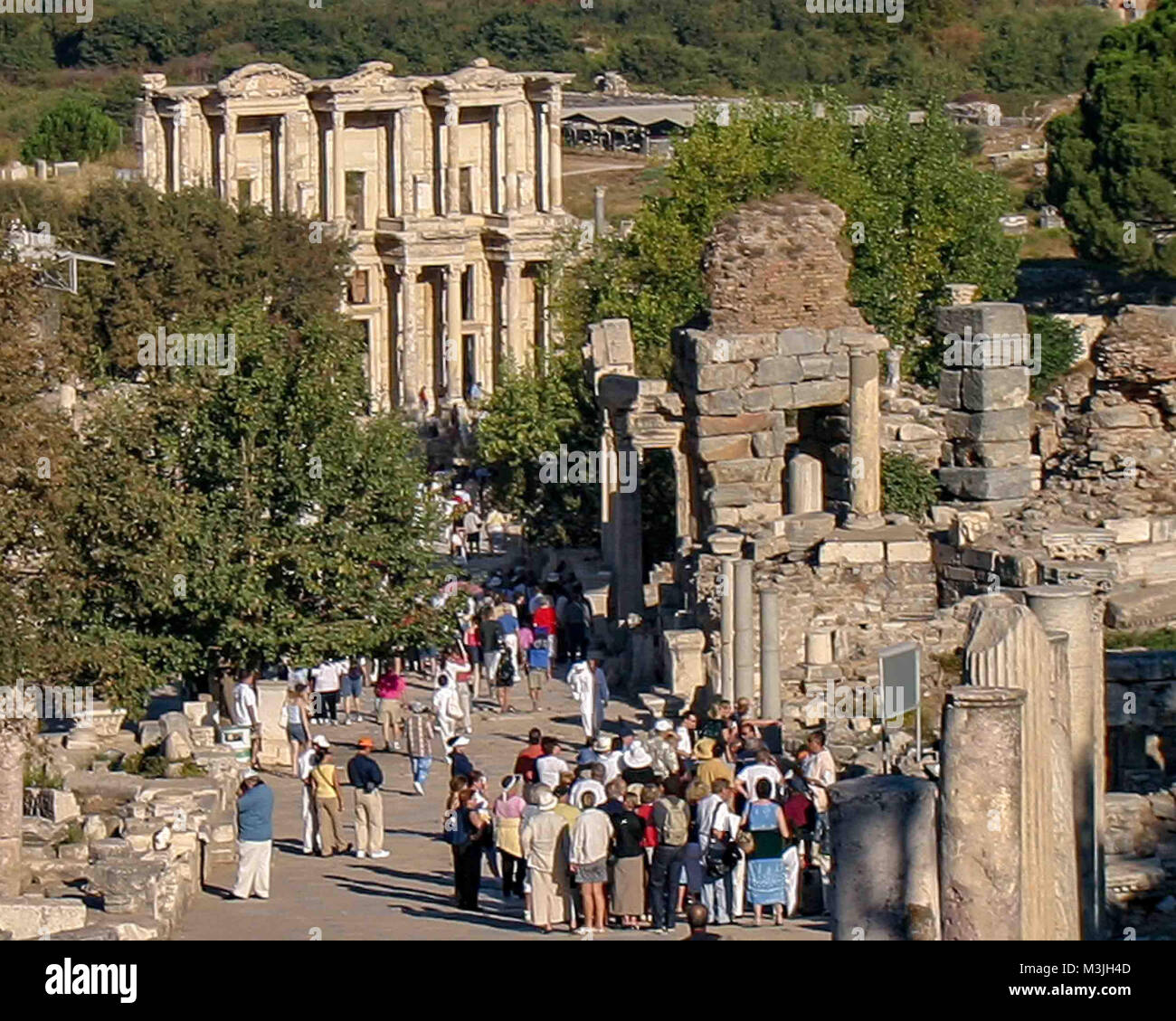 Ephesus, Izmir, Turkey. 1st Oct, 2004. A large group of tourists walk towards the Library of Celsus, the tomb for the Roman governor of the province of Asia. Built in 117 A.D. it is one of the most beautiful and most photographed structures in Ephesus. An ancient Greek city on the Ionian coast, dating to the 10th century BC, Ephesus was a religious, cultural and commercial center noted for its temples and architecture. Its ruins are now a favorite international tourist attraction and a UNESCO World Heritage Site. Credit: Arnold Drapkin/ZUMA Wire/Alamy Live News Stock Photo