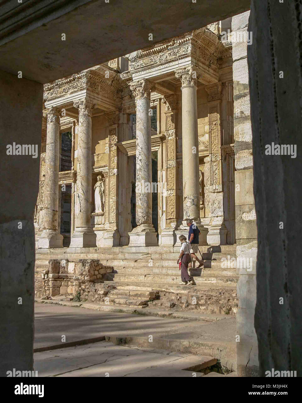 Ephesus, Izmir, Turkey. 1st Oct, 2004. A tourist couple descend the steps of the Library of Celsus, a tomb for the Roman governor of the province of Asia. Built in 117 A.D. it is one of the most beautiful and most photographed structures in Ephesus. An ancient Greek city on the Ionian coast, dating to the 10th century BC, Ephesus was a religious, cultural and commercial center noted for its temples and architecture. Its ruins are now a favorite international tourist attraction and a UNESCO World Heritage Site. Credit: Arnold Drapkin/ZUMA Wire/Alamy Live News Stock Photo